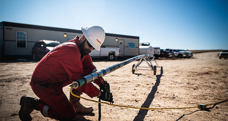 AnTech worker tightening strap on some tubing