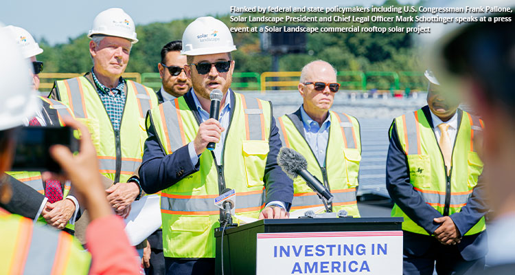 Flanked by federal and state policymakers including U.S. Congressman Frank Pallone, Solar Landscape President and Chief Legal Officer Mark Schottinger speaks at a press event at a Solar Landscape commercial rooftop solar project