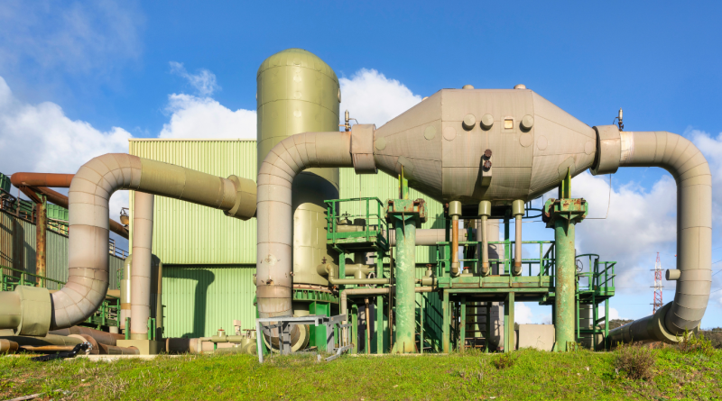 Geothermal power plant with thermal energy infrastructure and steam pipes.