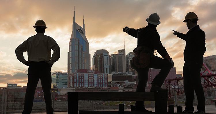 Oil workers overlook city scape