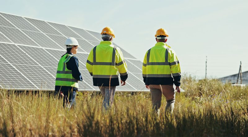 Solar panels and construction workers for Clean energy projects
