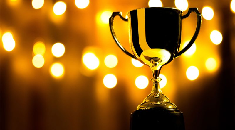 Trophy on stand with lights in background to support EOG Tech Awards UK