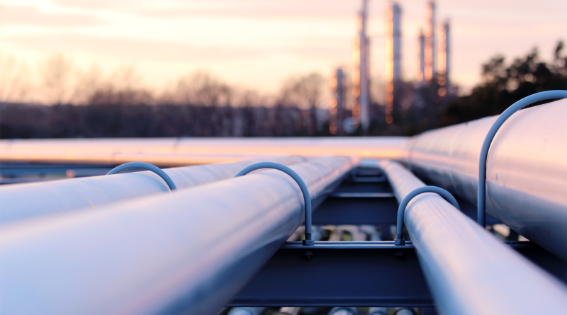 Steel long pipes in crude oil factory during sunset