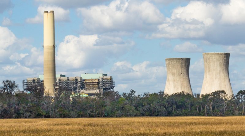 Two cooling towers and a nuclear power generating plant