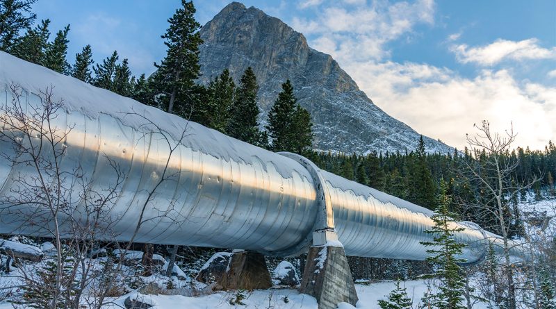 Canadian parliament building with national flag and oil pipeline concept overlay reflecting new pipeline policy shift